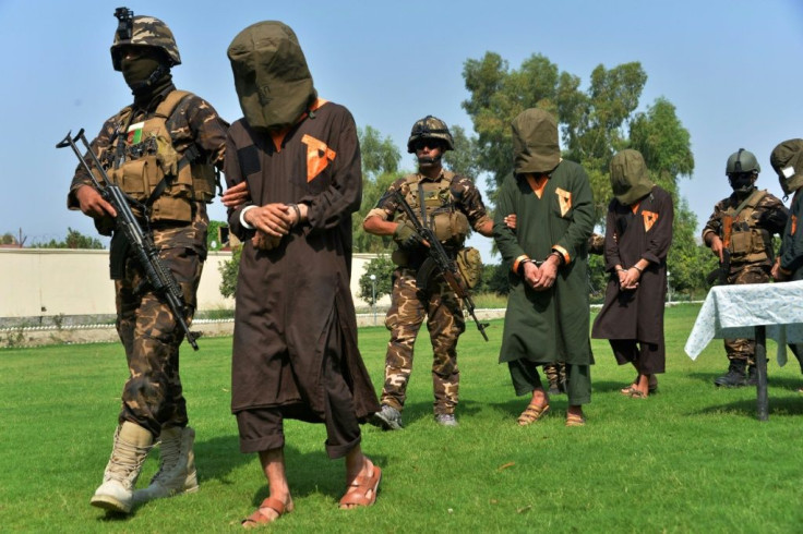 Afghan security personnel escort alleged Islamic State militants during an operation in Jalalabad province in October 2019. Officials say the IS Afghan branch has been defeated in one of the eastern provinces