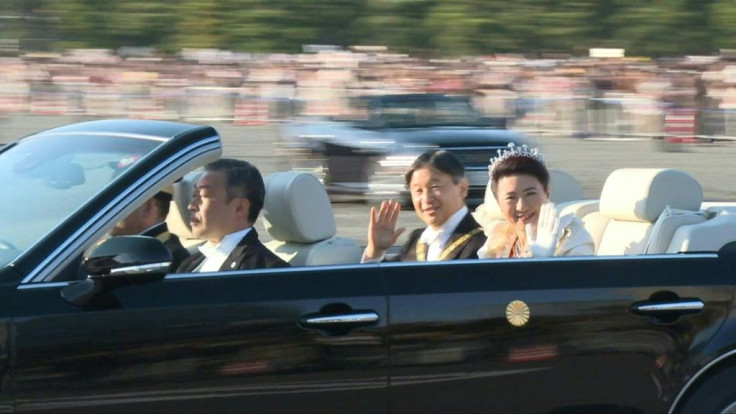Thousands of flag-waving spectators gather to cheer Japan's new Emperor Naruhito during a rare open-top car imperial parade that was rescheuled after a deadly typhoon