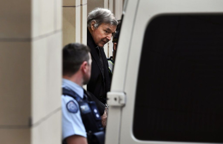 Australian Cardinal George Pell is escorted in handcuffs from the Supreme Court of Victoria in Melbourne on August 21, 2019.