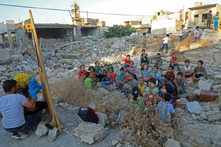 Walid Abu Rashed has carried on with his puppet despite years of violence in Syria's Idlib province