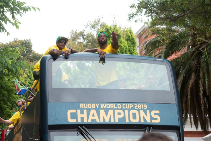 Springbok Captain Siya Kolisi, centre, atop the victory bus. Kolisi rose from extreme poverty to hoist the Rugby World Cup -- an odyssey that has inspired many in South Africa