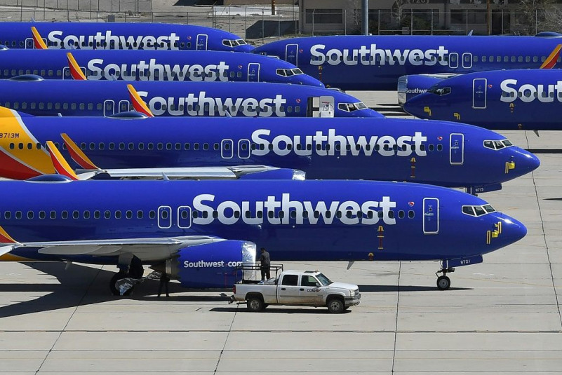 These Southwest Airlines planes, seen on a tarmac in California, were among the Boeing 737 MAX aircraft grounded in March after two fatal crashes; Boeing now  hopes the model will be cleared to fly in January, while some airlines are aiming for March