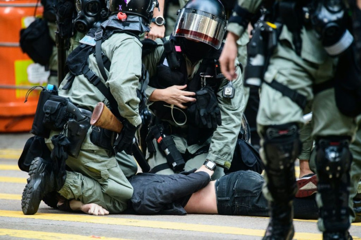 A man being detained by police during a protest in Hong Kong's Central district on November 11, 2019