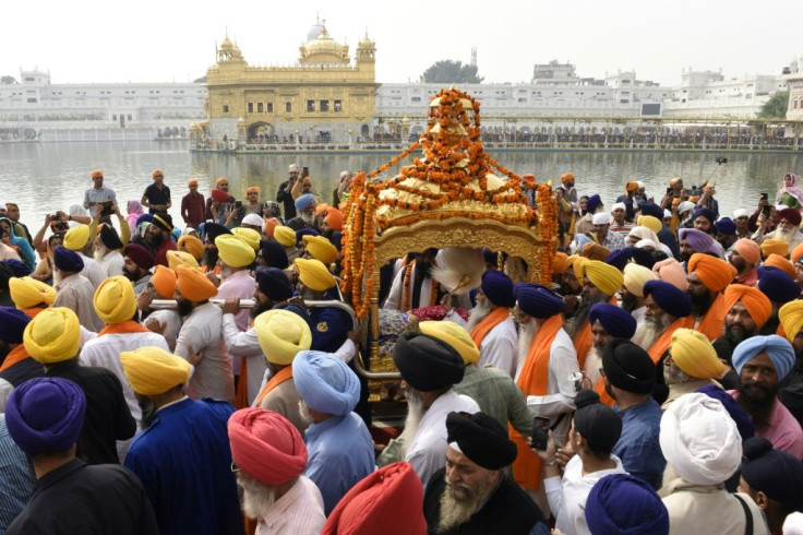 Devotees carry the Sikh holy book during a procession in Amritsar