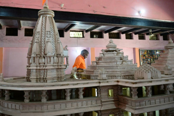 A model of the 'approved' temple is on display at the entry to the noisy workshop