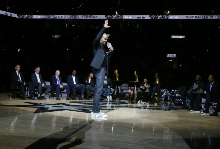 Retired San Antonio Spurs star guard Tony Parker waves to spectators during a ceremony Monday at which the NBA club retired his number nine jersey