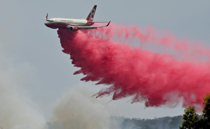 Planes and helicopters were used to splatter a built-up neighbourhood with water and red retardant