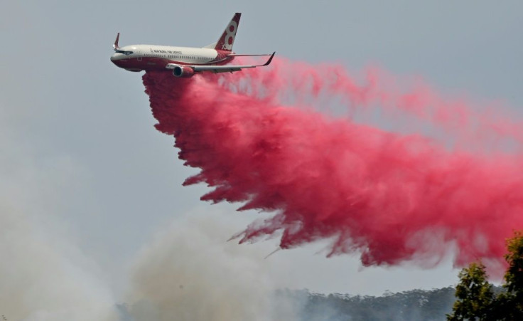 Planes and helicopters were used to splatter a built-up neighbourhood with water and red retardant