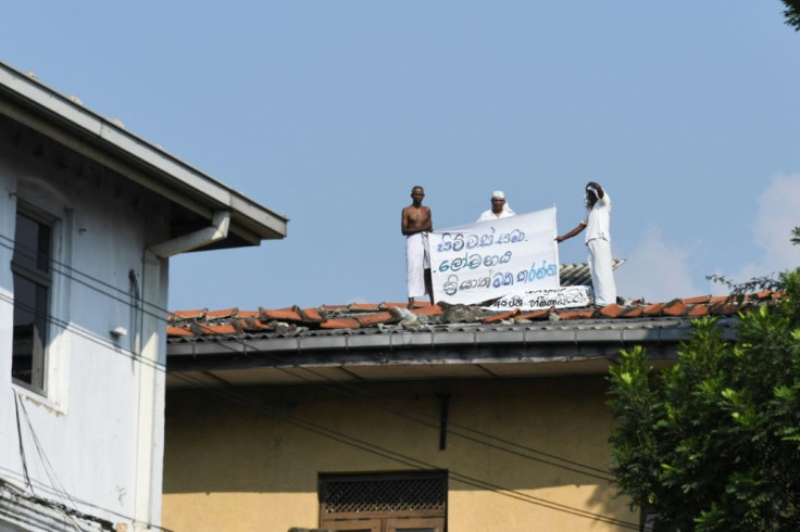 Inmates on the roof of Welikada prison in Sri Lanka display a banner calling for a pardon similar to that granted the murderer of a Swedish teen at the weekend
