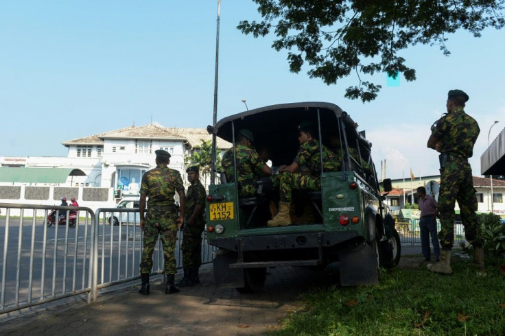 Special Task Force soldiers stand guard near Welikada prison as a protest by inmates entered a second day