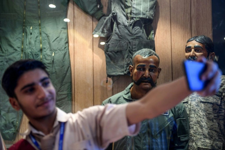 A Pakistan student in Karachi takes a selfie in front of the statue of Indian pilot Wing Commander Abhinandan Varthaman who was shot down over Kashmir earlier this year