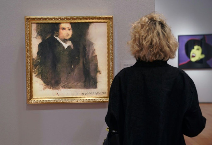 A woman examines "Portrait of Edmond Belamy" an AI work created by Obvious, which sold for $432,500 at Christie's in October 2018