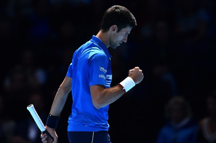 Novak Djokovic celebrates winning the first set against Dominic Thiem during their round-robin match at the ATP Finals