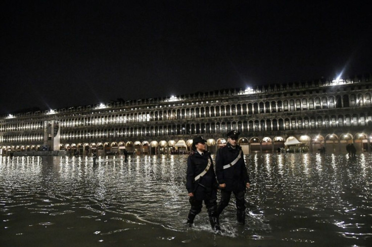 Police patrol flooded St. Mark's Square in Venice on November 12