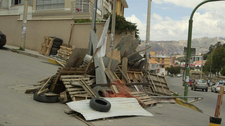 After two nights of violence across the city, locals in La Paz, where street barriades remain in place, have mixed feelings about Evo Morales leaving the country.