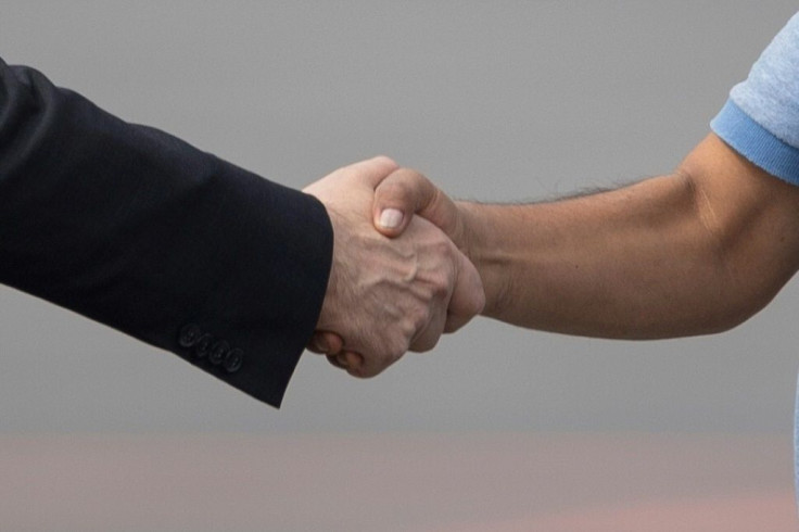 Mexican Foreign Minister Marcelo Ebrard (L) shakes hands with Bolivian ex-President Evo Morales upon his arrival in Mexico City, on November 12, 2019, where he was granted asylum after his resignation