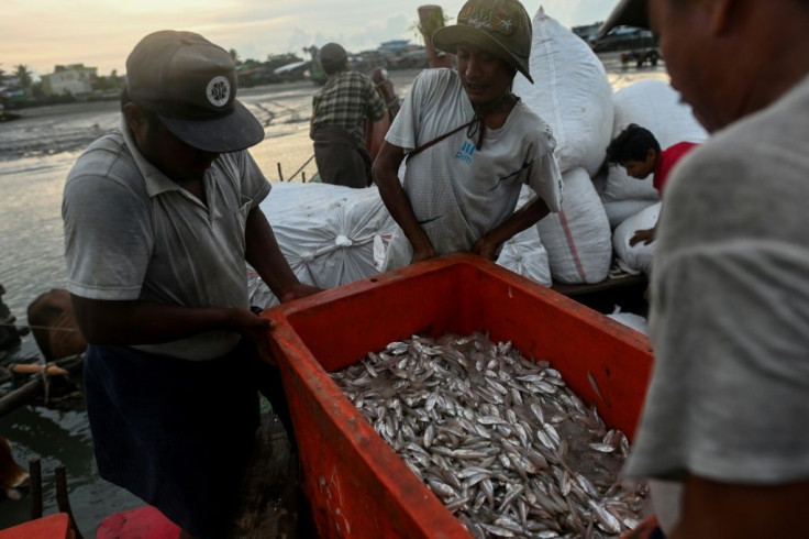 Aung Gyi is forced to fish covertly under the shroud of night in western Myanmar waters -- China may be trying to transform the strategically key region into a shipping and industrial hub -- but locals and activists fear they are being left out of the go