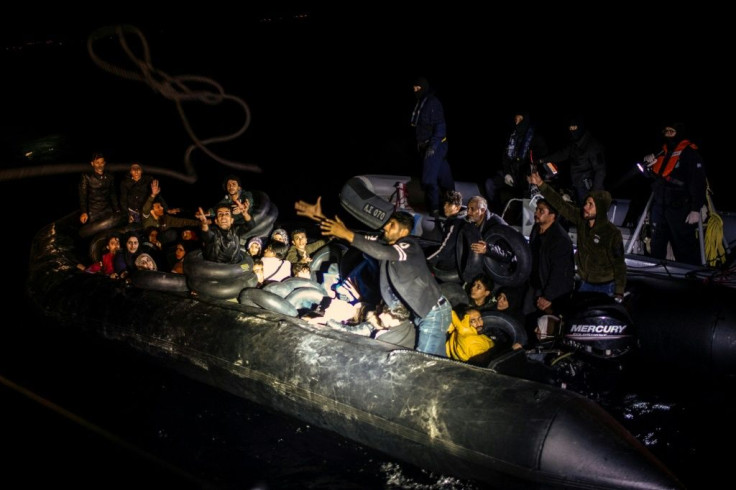 From a distance, just a handful of people can be seen sitting on the sides of the dinghy, but it soon becomes clear that it is packed