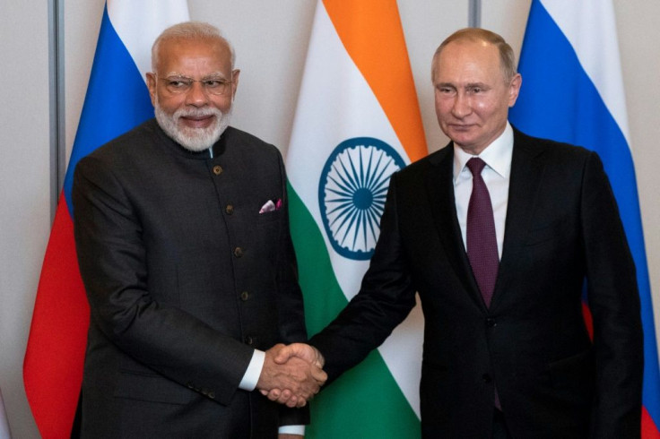 Russian President Vladimir Putin (R) and Indian Prime Minister Narendra Modi shake hands during their meeting on the sidelines of the BRICS summit, in Brasilia, Brazil, on November 13, 2019.