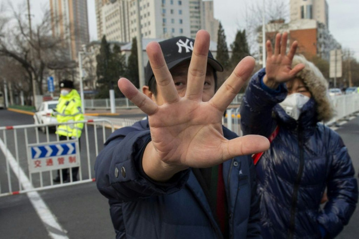 Plainclothes police officers stop photographs outside the court where the human rights lawyer Wang Quanzhang was tried in December 2018