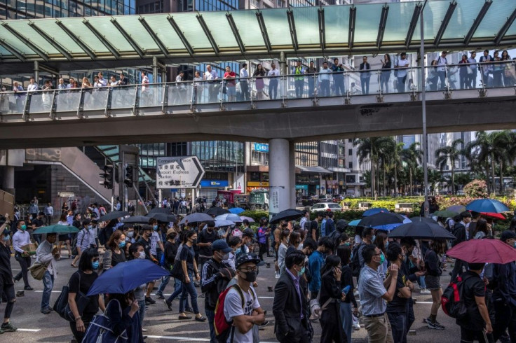 Thousands of office workers in the financial hub took to the streets during their lunch break in support of anti-government protests