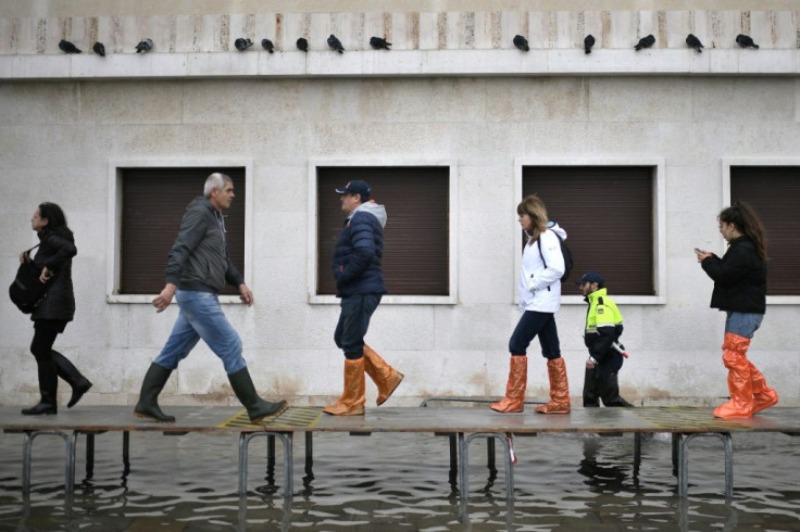 Officials erected a footbridge across a flooded street after the tide hit