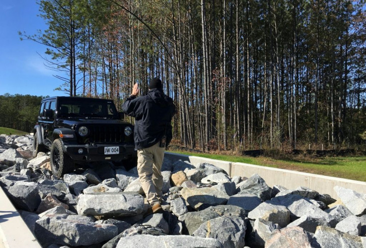 A driver attempts to navigate a Jeep over rocks during a media tour of a new training facility for US personnel overseas