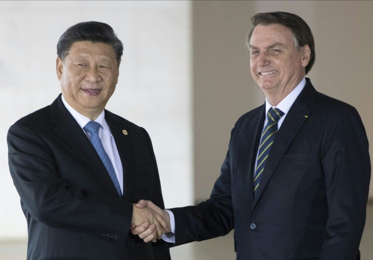 Brazil's President Jair Bolsonaro(R) and China's President Xi Jinping shake hands before the 11th BRICS Summit at the Itamaraty palace on November 14, 2019 in Brasilia, Brazil