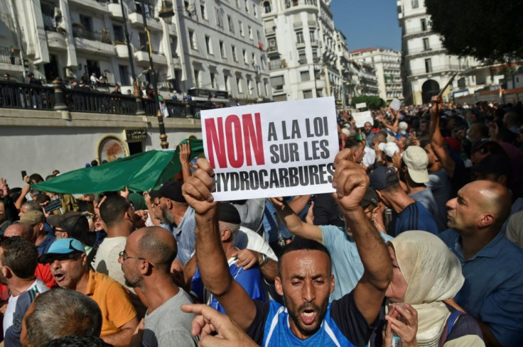 Algerian protesters chant anti-government slogans near the parliament building in Algiers on October 13, 2019 against the military's role in politics and a draft energy law