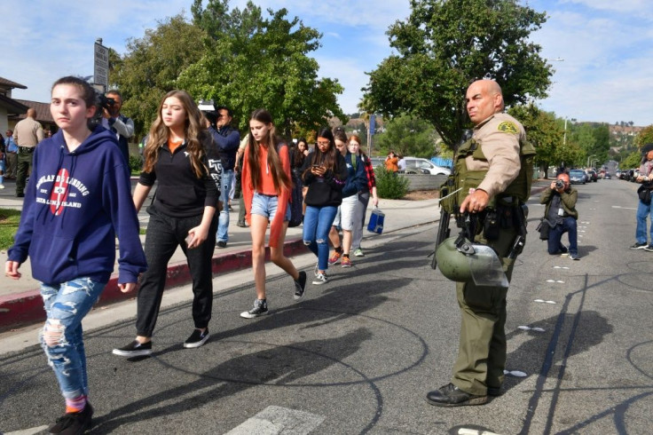 Students line up after a shooting at Saugus High School in Santa Clarita, California