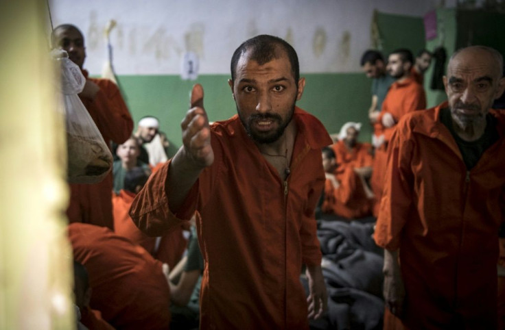 Men suspected of being affiliated with the Islamic State group gather in a prison cell in the northeastern Syrian city of Hasakeh in October 2019