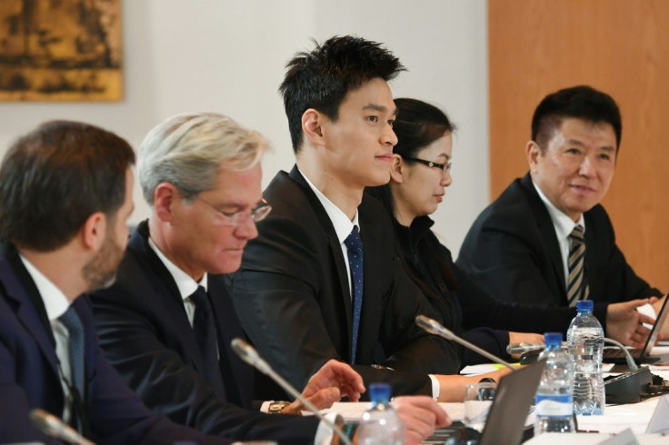 China's swimming star Sun Yang (C), flanked by his lawyers, attends the Court of Arbitration for Sport