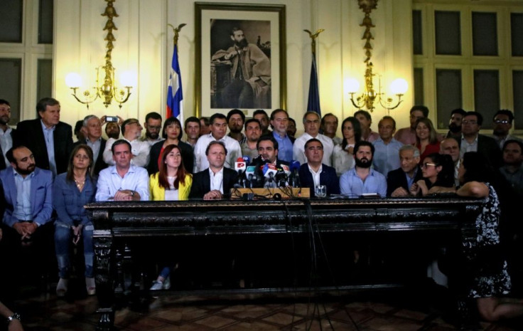 A photo released by Aton Chile shows Chilean legislators during a press conference on the mechanisms to create a new Constitution at the former National Congress in Santiago