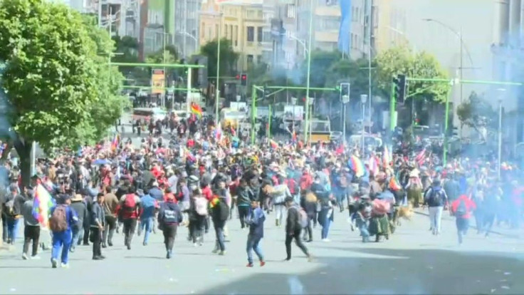 Police fire tear gas at demonstrators protesting against Bolivia's interim president Jeanine Anez in the capital