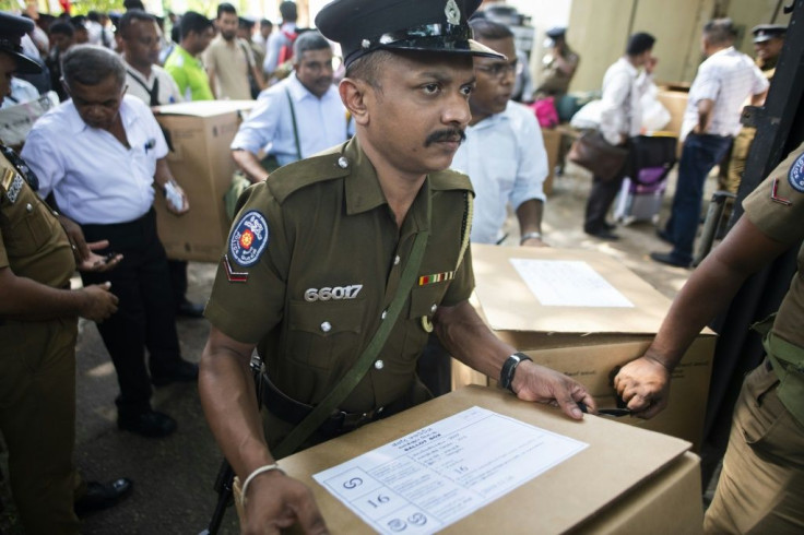 Police and electoral officials collect ballot papers ahead of Saturday's polls