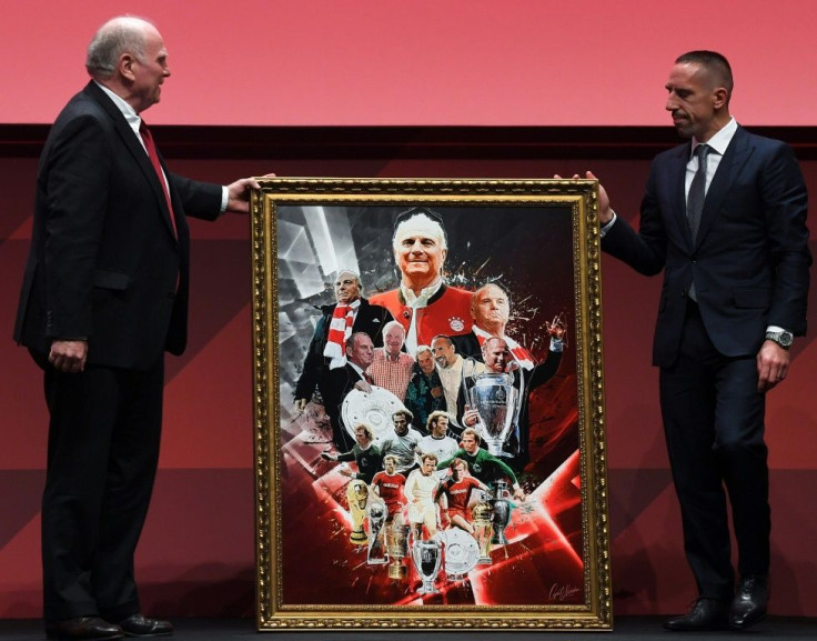 Former France winger Franck Ribery (R) presents outgoing Bayern Munich president Uli Hoeness (L) with a portrait at the club's annual general meeting
