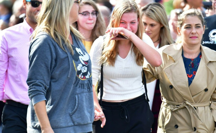 Grieving students from Saugus High School reunite with their parents at Central Park in Santa Clarita, California