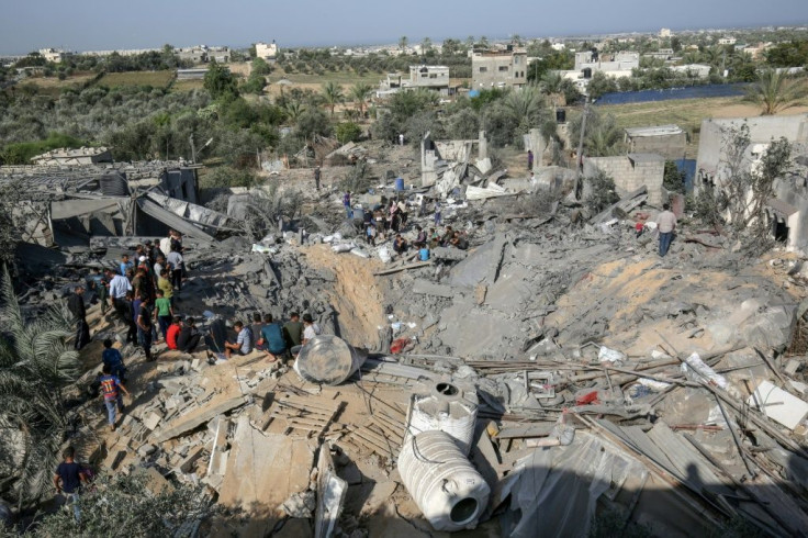 Palestinians salvage what they can from the wreckage of a building flattened by an Israeli air strike on the Gaza Strip city of Khan Yunis on Thursday