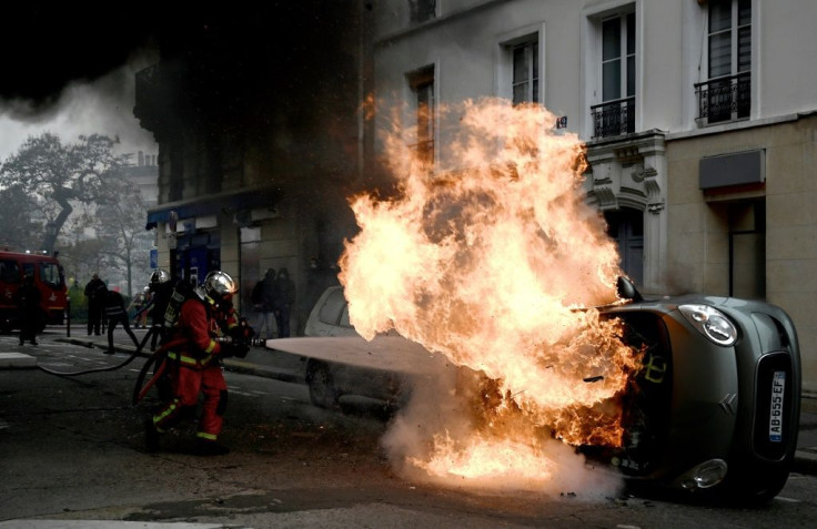 Police in riot gear were deployed at the Place d'Italie after an overturned car was set alight and stones were thrown