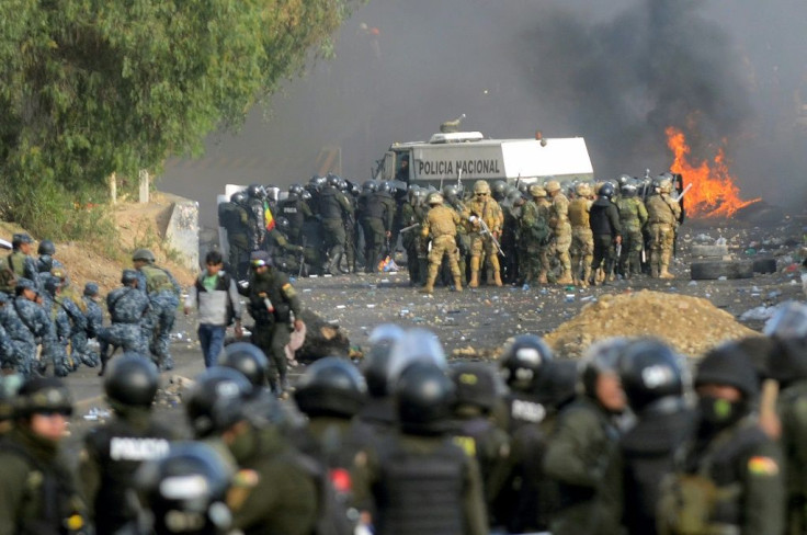 Bolivian riot police and soldiers clash with supporters of ex-President Evo Morales during a protest in the Cochabamba department on November 15