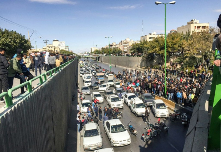 Iranian protesters block a road in the central city of Isfahan during a demonstration against an increase in gasoline prices