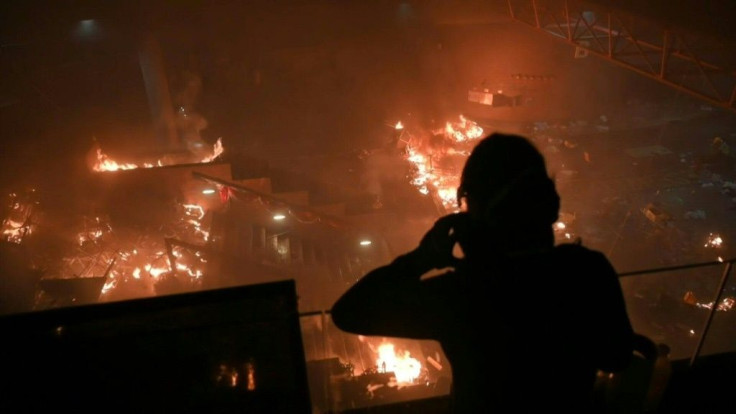 A large fire burns near an entrance to a besieged Hong Kong campus after protesters threw Molotov cocktails to fend off a police advance on the university, according to AFP reporters at the scene.
