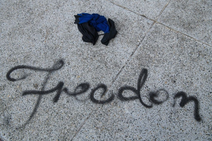 The English word "freedom" was spray-painted in cursive letters on a walkway