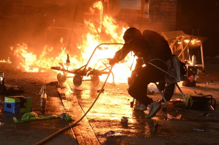 Sporadic fires flared throughout Monday around the campus entrances, lit by protesters as defensive barriers