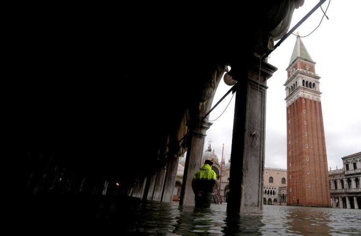 Schools reopened in Venice as shopkeepers with mops and buckets in hand tried to muck out the water and mud that flooded their stores