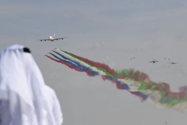 The UAE air force aerobatic team performs at the Dubai Airshow with an Airbus A380 superjumbo, which airlines have struggled to fill to capacity