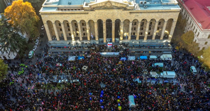 More than 20,000 demonstrators rallied outside the parliament building in Tbilisi urging the government to resign and calling for new legislative elections