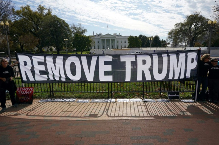 Activists hold a banner asking for the impeachment of US President Donald Trump on November 5, 2019 in front of the White House in Washington, DC