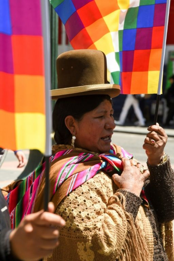 A supporter of Bolivian ex-President Evo Morales holds a Wiphala flag -- representing indigenous peoples -- in La Paz