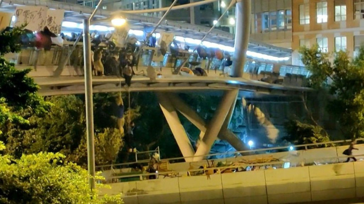 Dozens of Hong Kong protesters escape a two-day police siege at a university campus by shimmying down a rope from a bridge to awaiting motorbikes